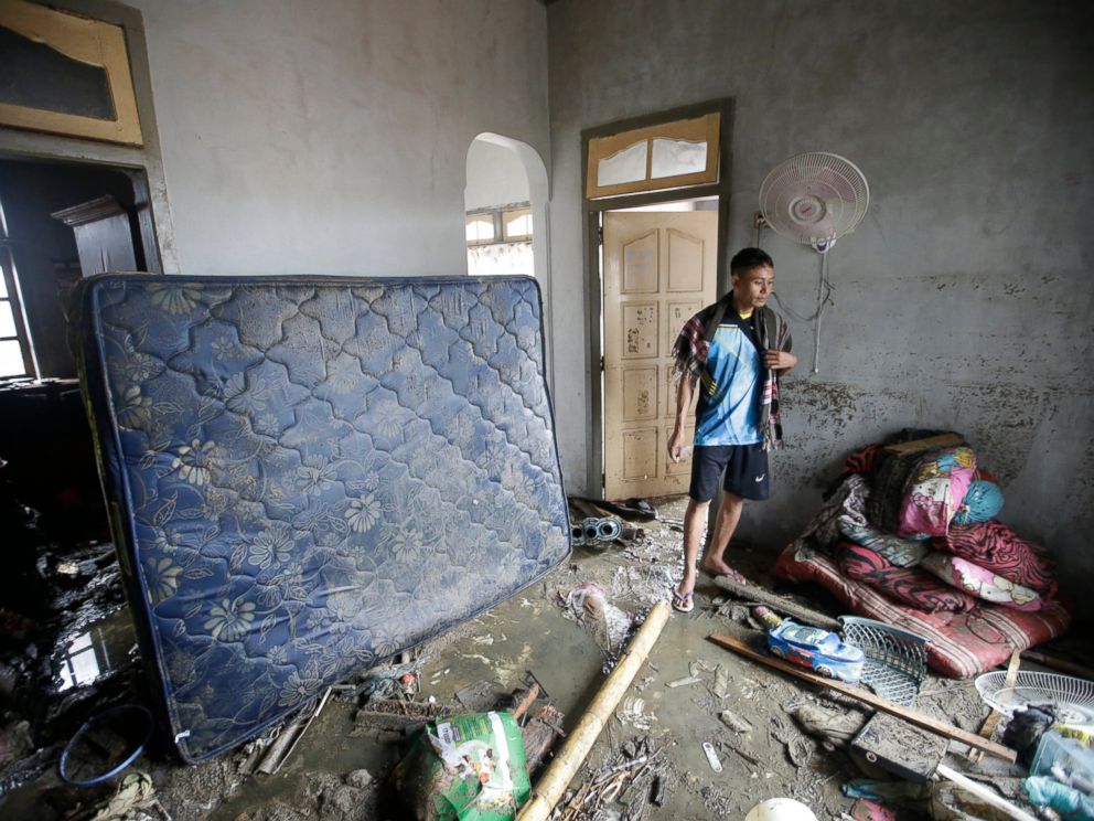 PHOTO: A tsunami survivor walks inside a house at a tsunami-ravaged village in Sumur, Indonesia, Tuesday, Dec. 25, 2018.