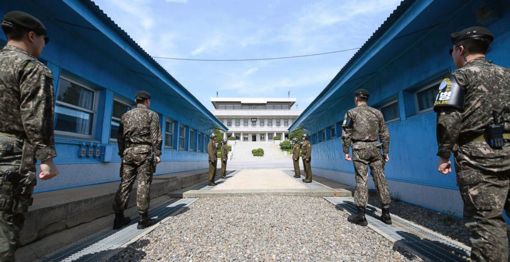 PHOTO: Four North Korean soldiers, far, and four South Korean soldiers, stand at the border village of Panmunjom in the Demilitarized Zone, South Korea, April 26, 2018, where the two Korean leaders will greet each other for their historic summit. 