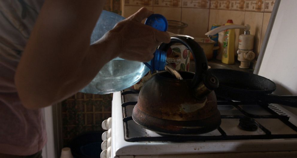 PHOTO: Victoria, a Ukrainian woman who described her ordeal under Russian occupation, pours tea in her home.
