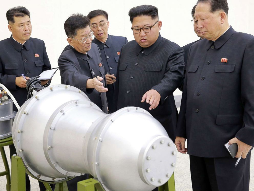 PHOTO: This undated picture released by North Korea's official Korean Central News Agency (KCNA) on September 3, 2017 shows North Korean leader Kim Jong-Un, center,looking at a metal casing with two bulges at an undisclosed location.