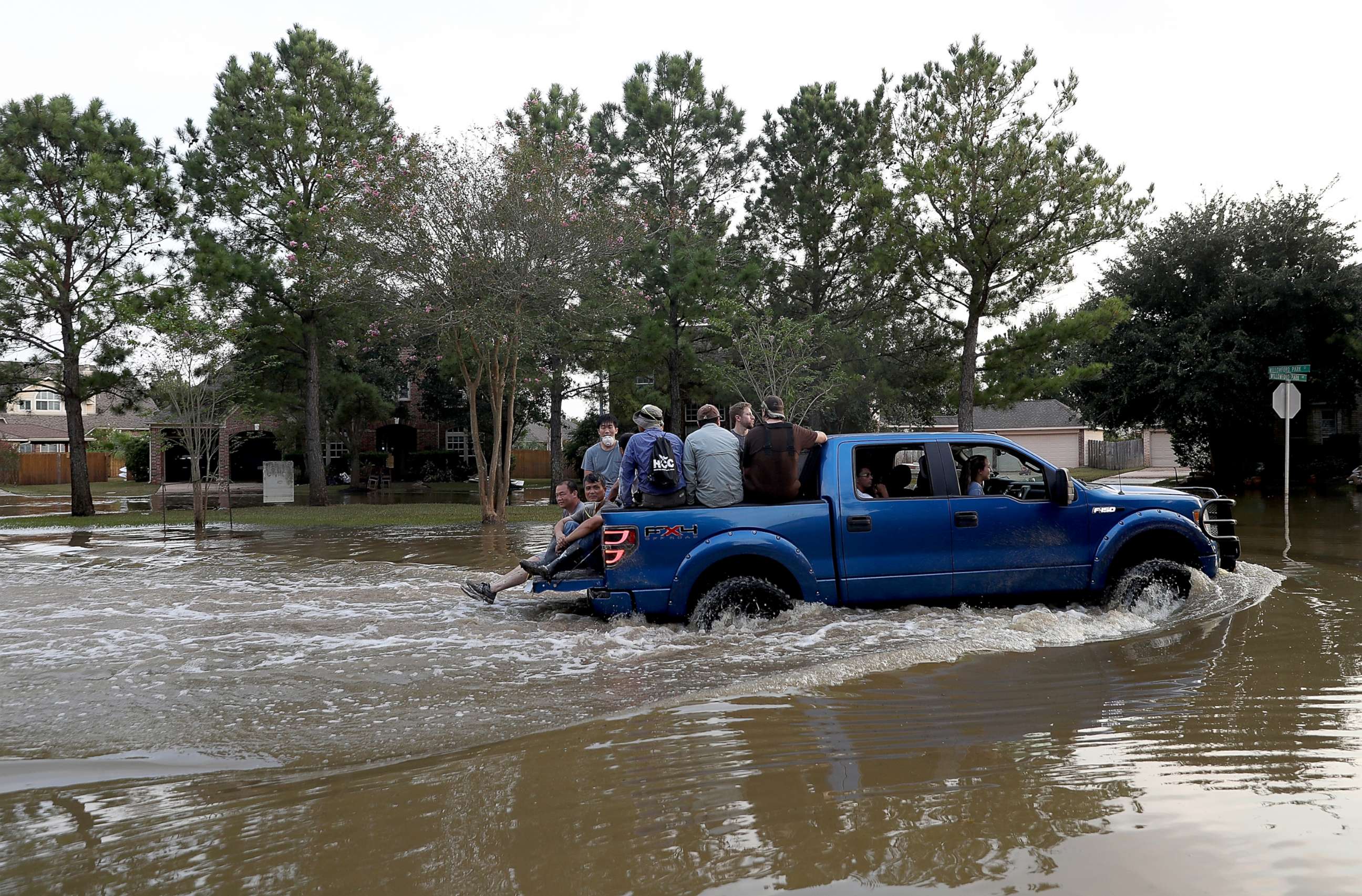 PHOTO:People ride through floodwaters,caused by Hurricane Harvey, in a four wheel drive truck on September 4, 2017 in Katy, Texas. A week after it hit Southern Texas, residents are beginning the long process of recovering from the storm. 