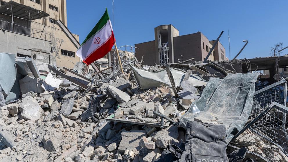 PHOTO: An Iranian flag is planted in the rubble of a police station, damaged in airstrikes yesterday, on March 3, 2026 in Tehran, Iran.