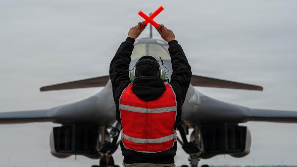 PHOTO: A U.S. Air Force B-1B Lancer crew chief marshals a B-1 after returning from a CONUS-to-CONUS mission in support of Operation Epic Fury, March 4, 2026.