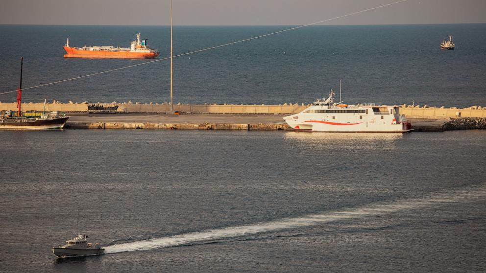 PHOTO: A police speed boat patrols the port as oil tankers and high speed crafts sit anchored at Muscat Anchorage near the Strait of Hormuz, March 30, 2026 in Muscat, Oman. r