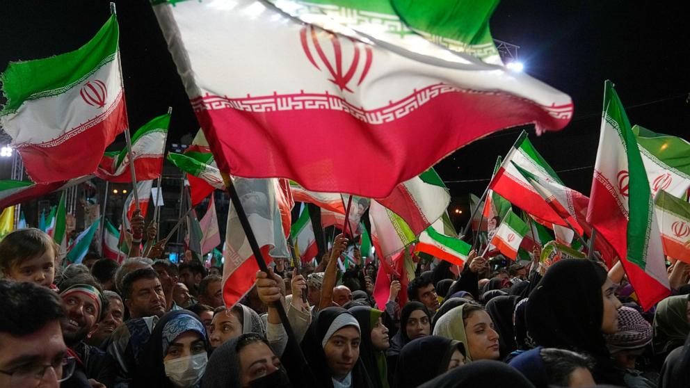 PHOTO: Government supporters wave Iranian flags in a pro-government gathering at Islamic Revolution Square in Tehran, Iran, May 13, 2026.
