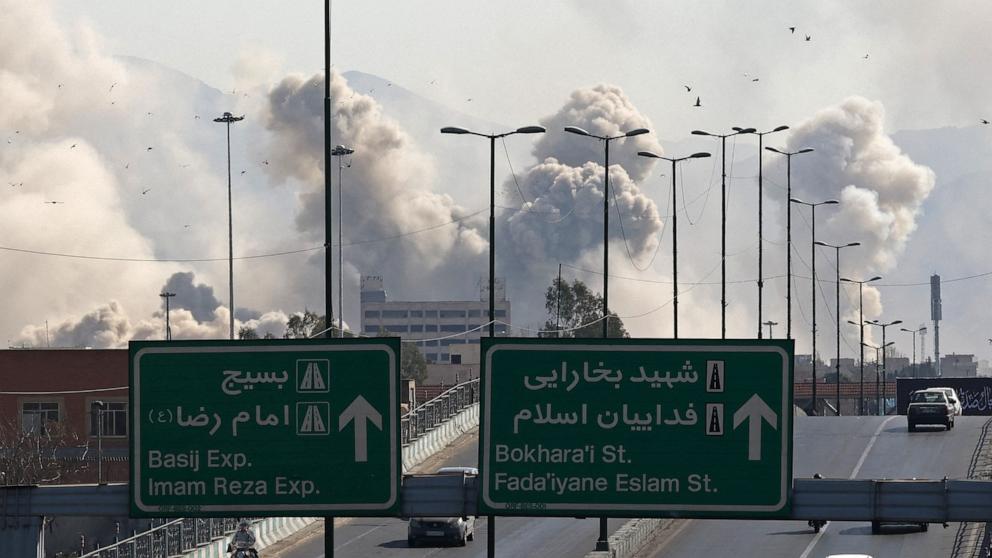 PHOTO: Vehicles drive along an expressway against the backdrop of smoke rising after a strike on the Iranian capital of Tehran, March 5, 2026.