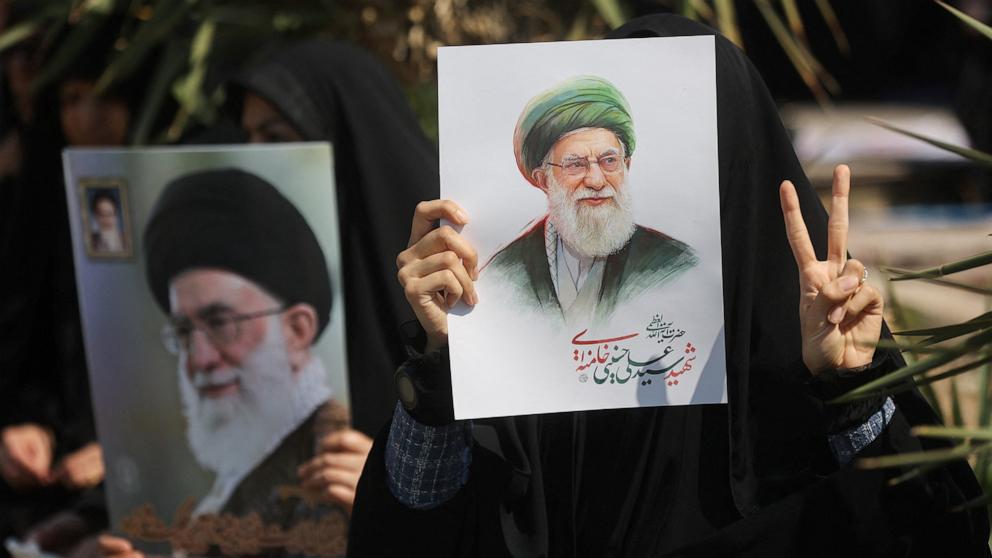 PHOTO: A woman gestures while holding an image of Iran's late Supreme Leader Ayatollah Ali Khamenei, on the day of an anti-Israeli and U.S. rally, amid the U.S.-Israeli conflict with Iran, in Tehran, Iran, March 6, 2026. 