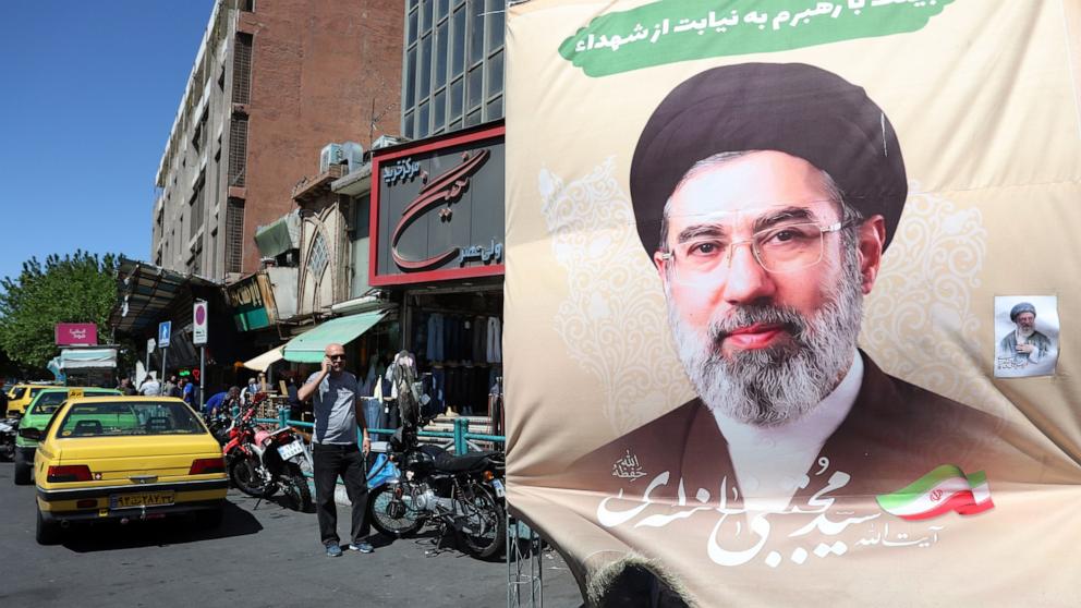 PHOTO: Iranians walk past a poster of Iranian supreme leader Ayatollah Mojtaba Khamenei in a street in Tehran, Iran, April 22, 2026. 