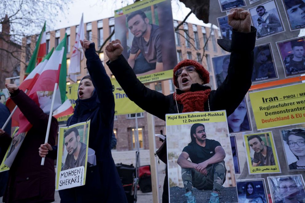 PHOTO: Protesters wear portraits of Majid Reza Rahnavard, 23, and Mohsen Shekari, 23, both of whom were recently executed by Iranian authorities, during a demonstration, Dec. 12, 2022 in Berlin.