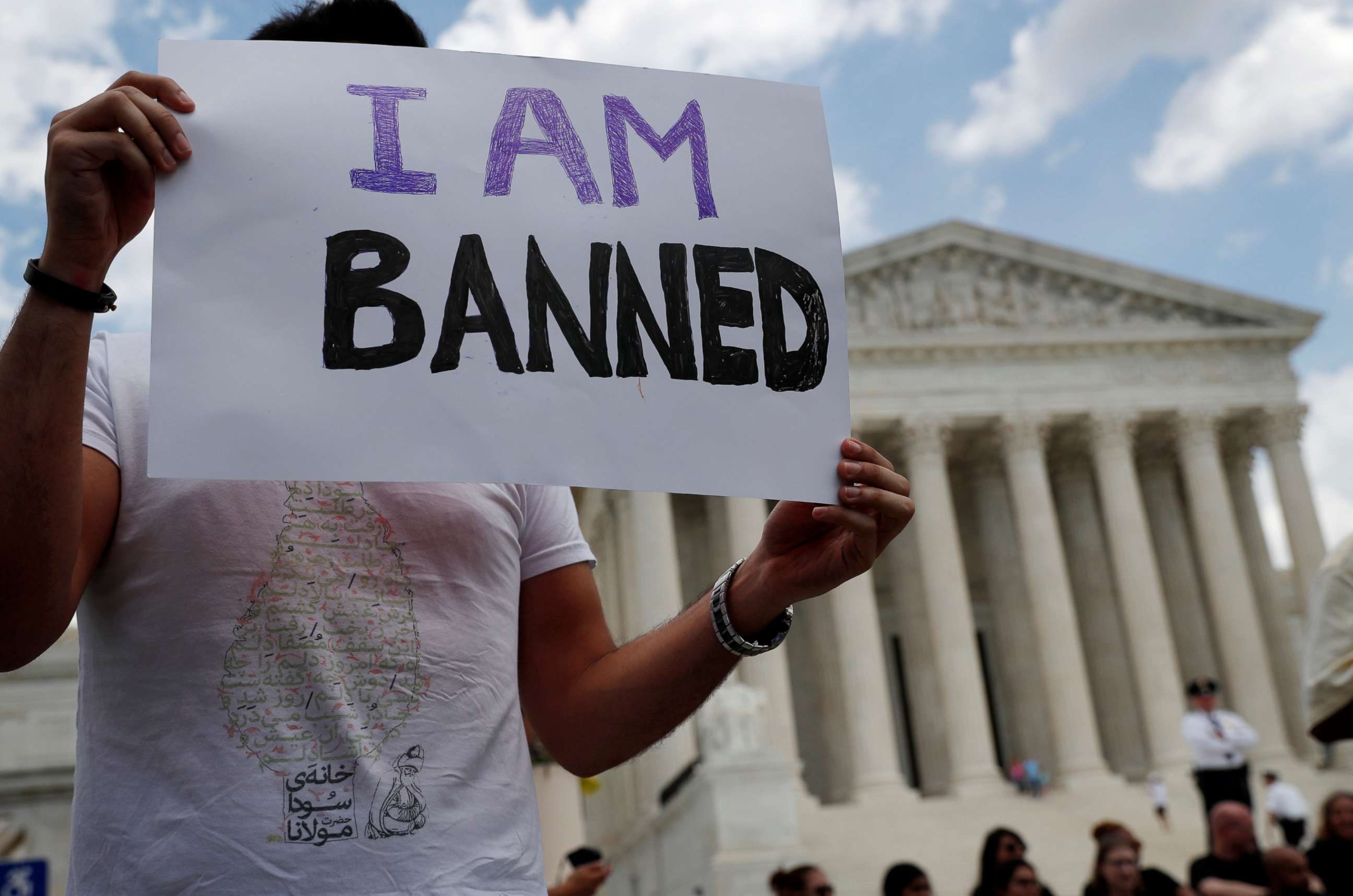 PHOTO: Mehrad Ansari of Iran holds a sign outside of the U.S. Supreme Court after U.S. President Trump's travel ban was upheld in Washington, D.C., June 26, 2018.