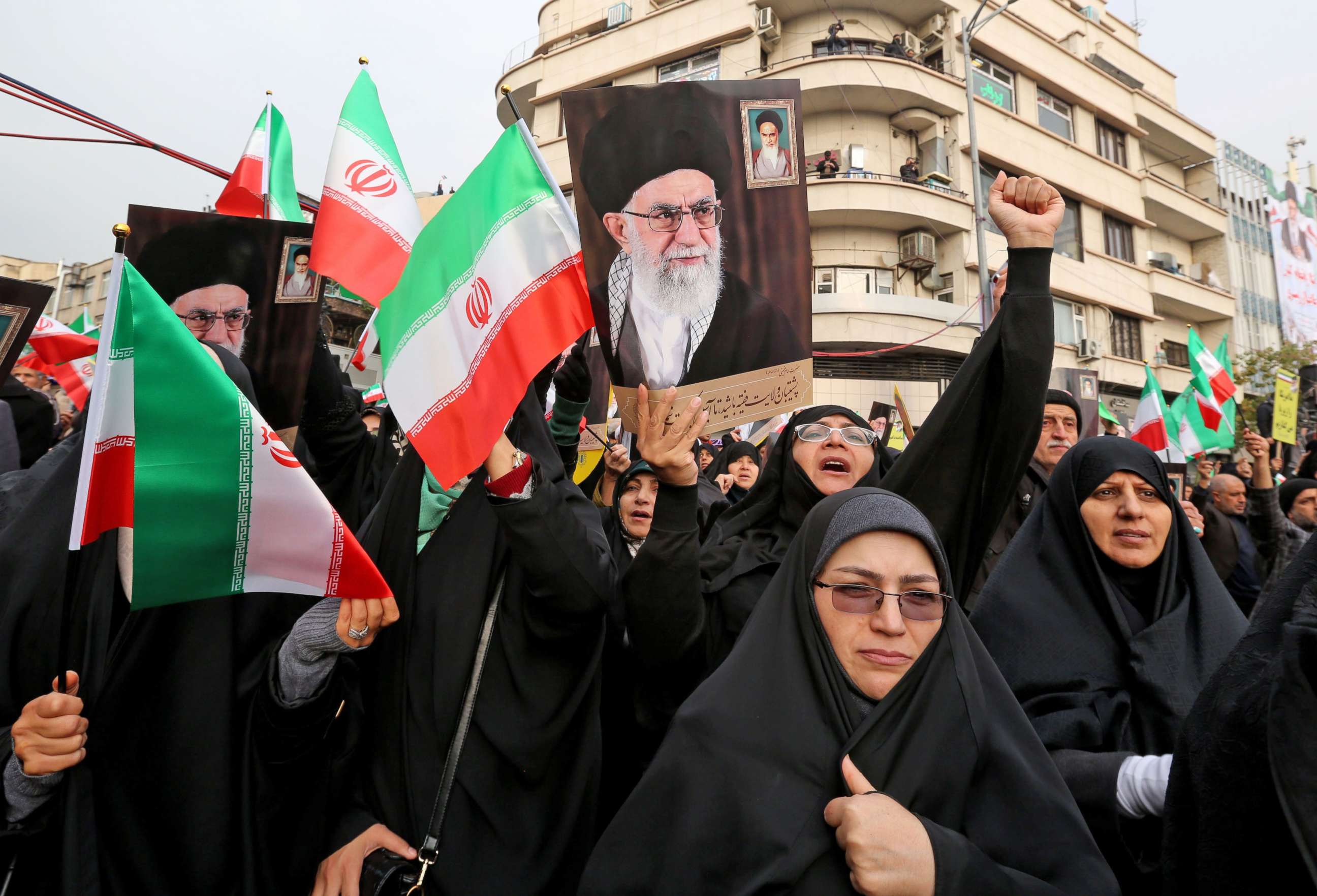 PHOTO: Iranian women holding national flags and pictures of the Islamic republic's supreme leader, Ayatollah Ali Khamenei, take part a pro-government demonstration in Tehran, Iran, Nov. 25, 2019.