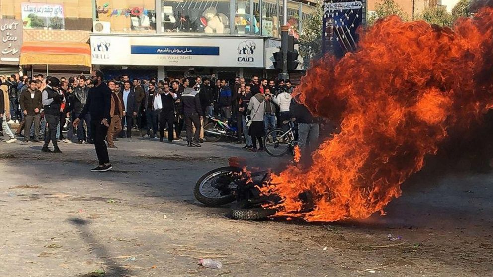 PHOTO: Iranian protesters gather around a burning motorcycle during a demonstration against an increase in gasoline prices in the central city of Isfahan, on Nov. 16, 2019.