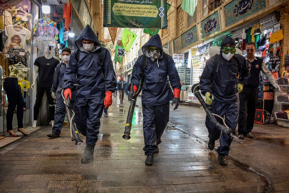 PHOTO: Iranian fire department staffs disinfect the public places against coronavirus at night using machinery and mobile pumps, March 16, 2020, in Tehran, Iran.