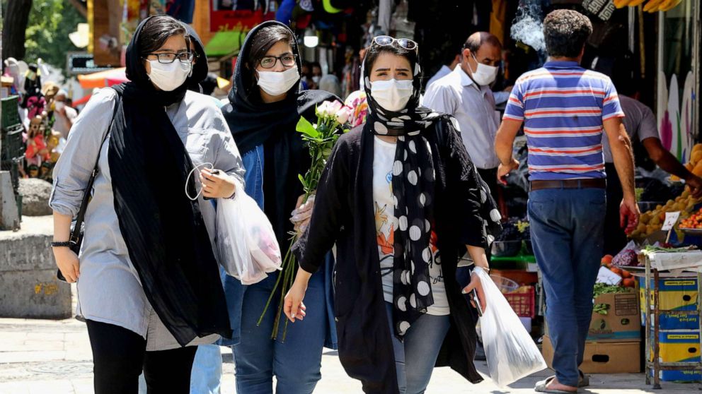 PHOTO: Iranian women wearing protective gear amid the COVID-19 pandemic, shop at the Tajrish Bazaar market in Tehran, on July 14, 2020.