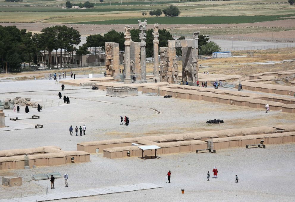 PHOTO: Tourists walk near ancient ruins of the Gate of All Nations at the Persepolis archeological site on May 30, 2014 in Persepolis, Iran.