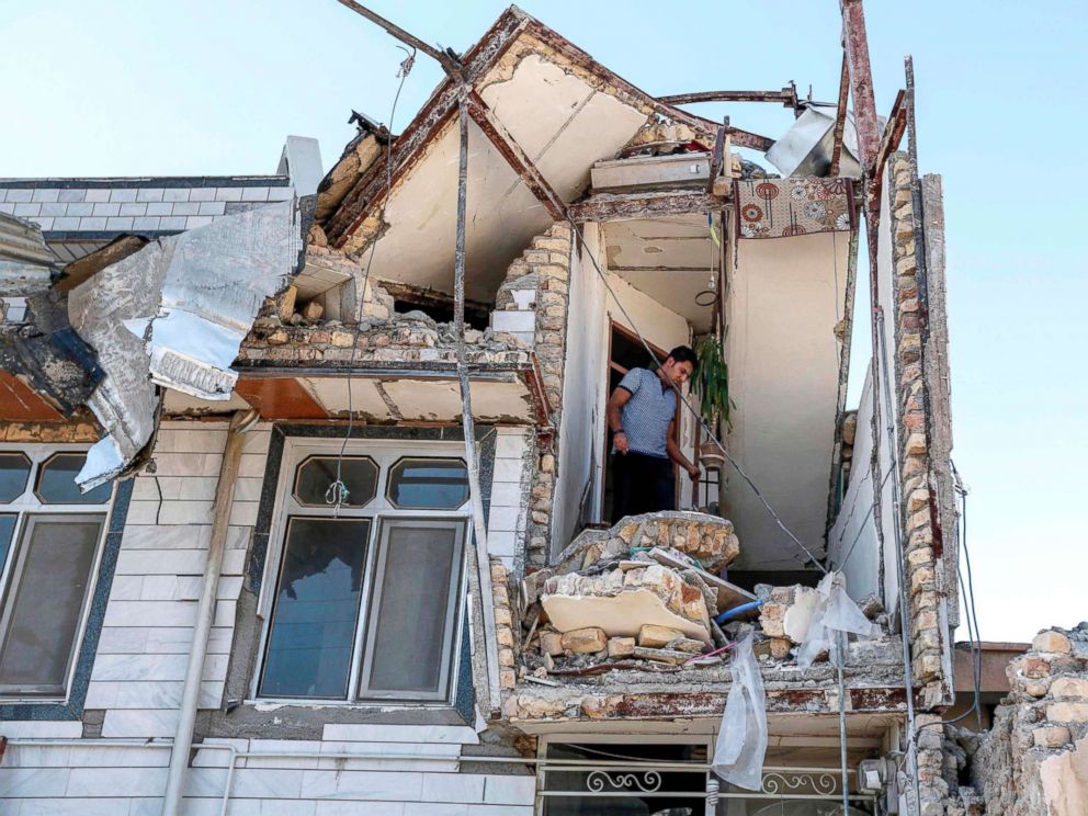 PHOTO: An Iranian man looks through the damaged stairwell of a building in the town of Sarpol-e Zahab in the western Kermanshah province near the border with Iraq, Nov. 14, 2017.