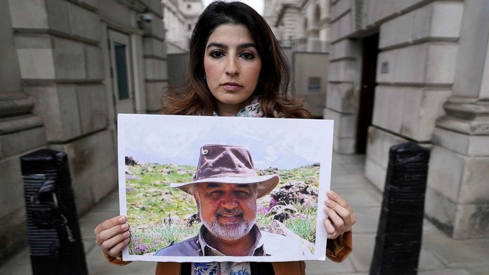 PHOTO: FILE - Morad Tahbaz detained in Iran. Roxanne Tahbaz, holds a picture of her father Morad Tahbaz, who is jailed in Iran, during a protest outside the Foreign, Commonwealth and Development Office (FCDO) in London, April 13, 2022.