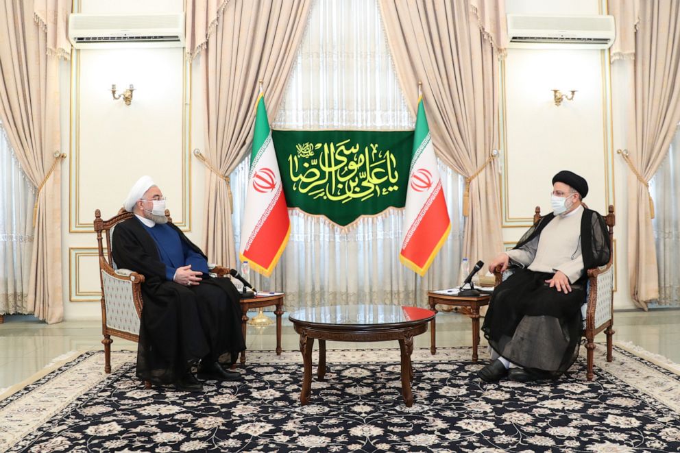 PHOTO: A handout photo made available by the presidential office shows, Iranian president Hassan Rouhani(L) and president-elect Ebrahim Raisi(R) during a meeting in Tehran, Iran, June 19, 2021. 