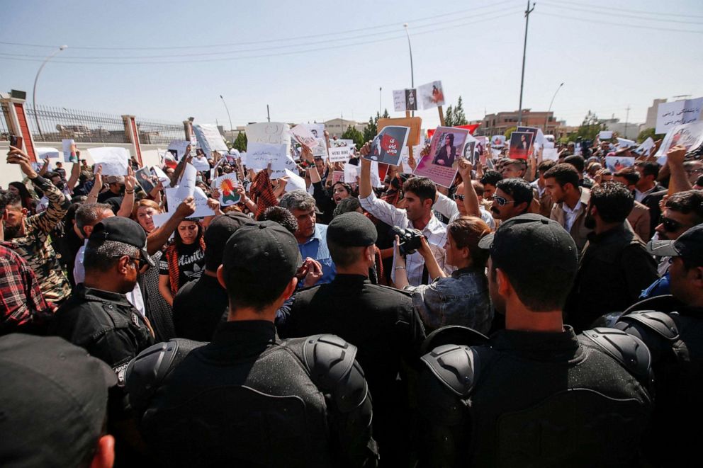 PHOTO: People take part in a protest following the death of Mahsa Amini in front of the United Nations headquarters in Erbil, Iraq, Sept. 24, 2022.