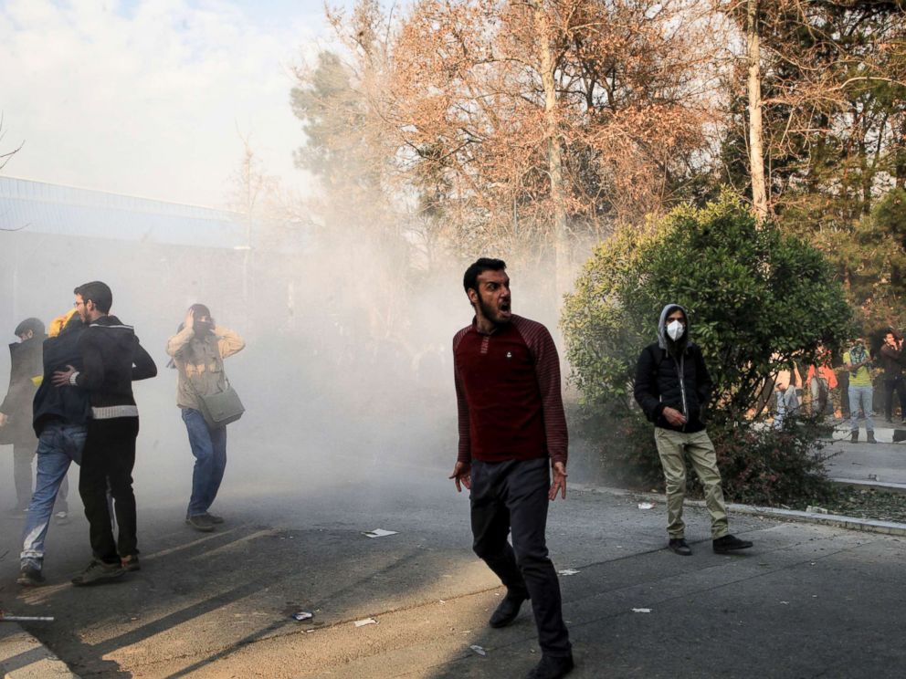 PHOTO: University students attend a protest inside Tehran University while a smoke grenade is thrown by anti-riot Iranian police, in Tehran, Iran, Dec. 30, 2017, in a photo obtained by AP.