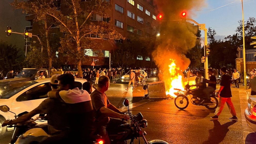 PHOTO: A police motorcycle burns during a protest over the death of Mahsa Amini, a woman who died after being arrested by the Islamic republic's "morality police", in Tehran, Iran, Sept. 19, 2022.