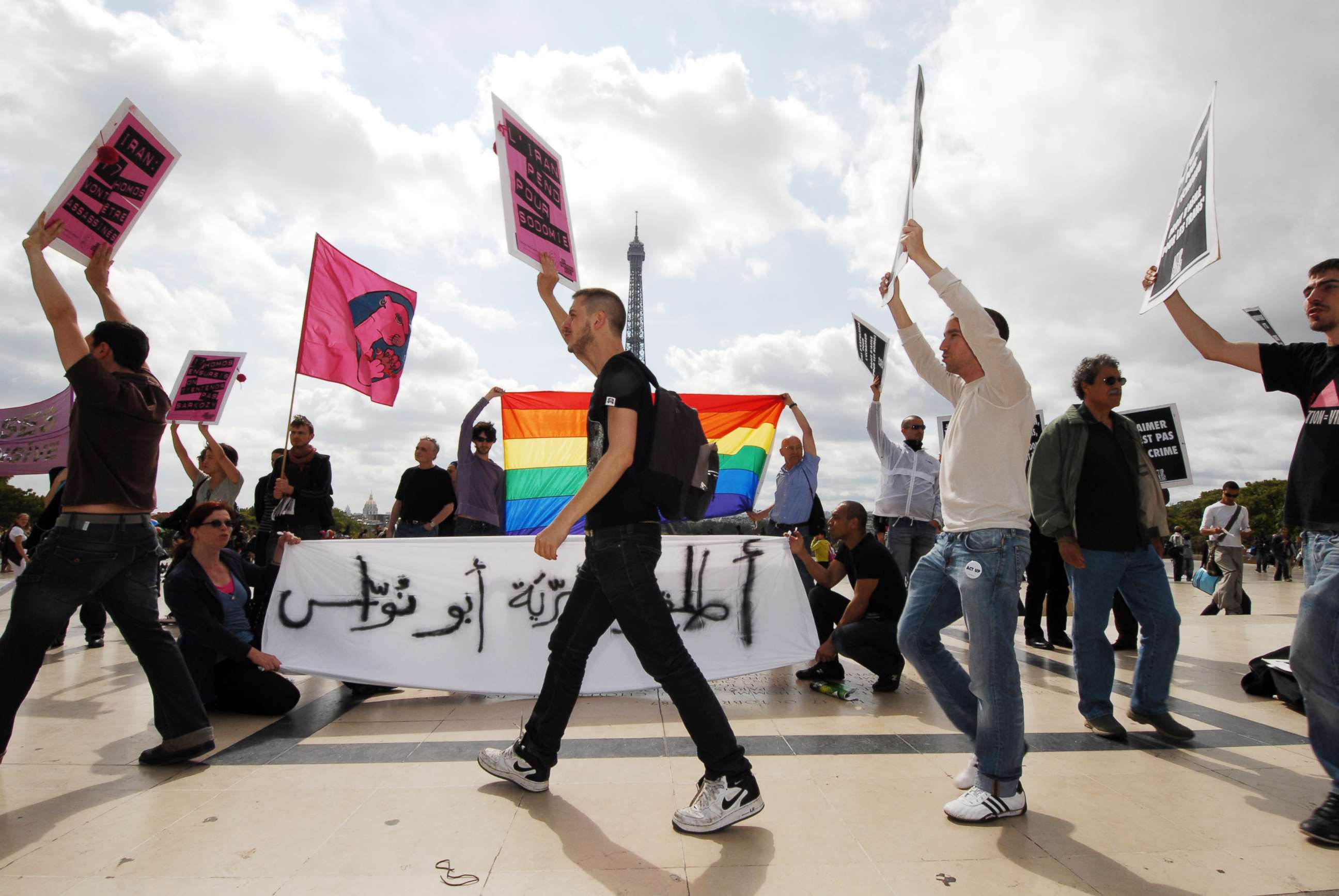 PHOTO: People hold banners protesting against discrimination and persecution against homosexuals in Iran, July 28, 2007, in front of the Eiffel tower in Paris.