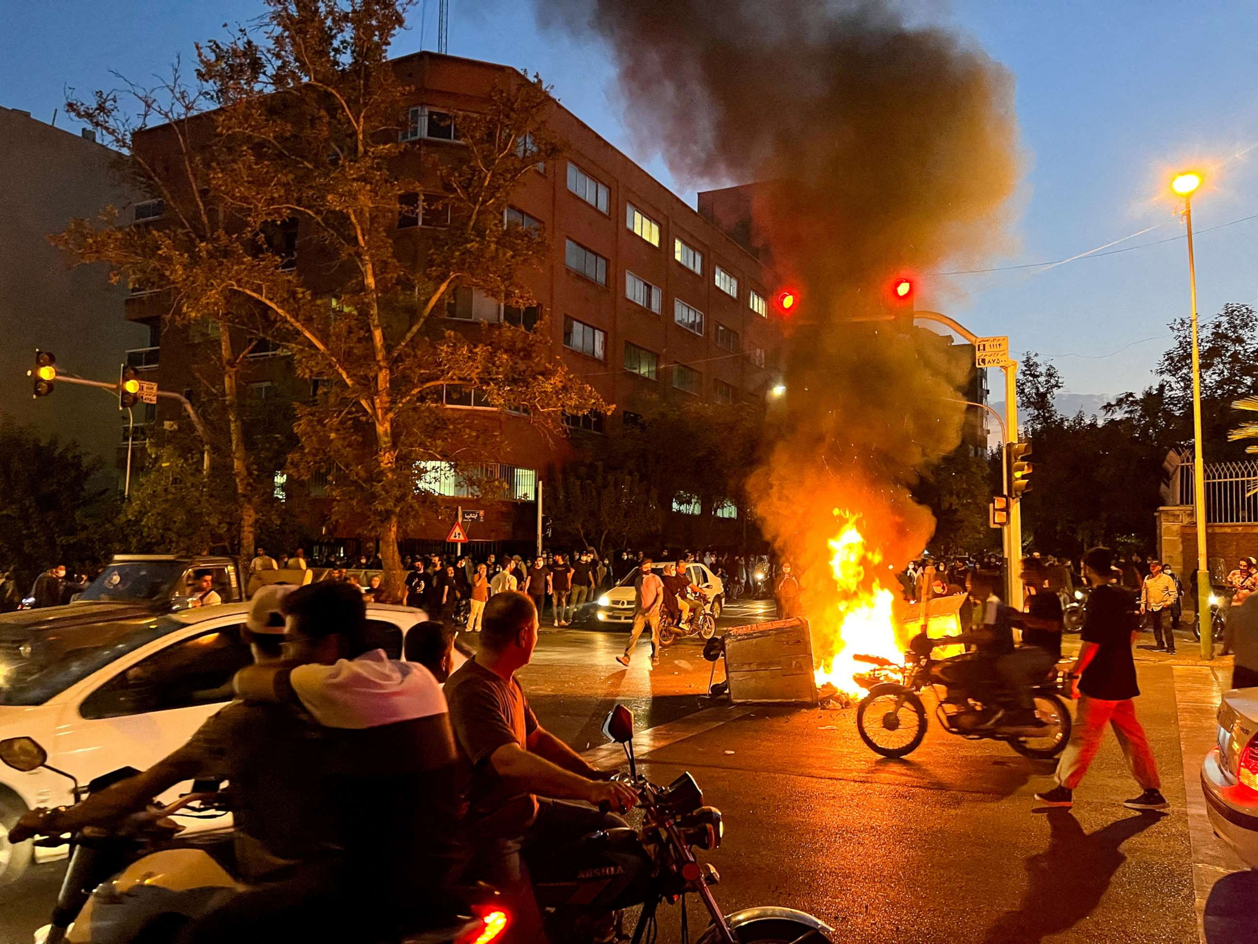PHOTO: A police motorcycle burns during a protest over the death of Mahsa Amini, a woman who died after being arrested by the Islamic republic's "morality police", in Tehran, Iran Sept. 19, 2022.