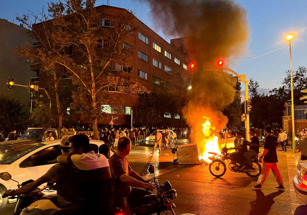 PHOTO: A police motorcycle burns during a protest over the death of Mahsa Amini, a woman who died after being arrested by the Islamic republic's "morality police", in Tehran, Iran Sept. 19, 2022.