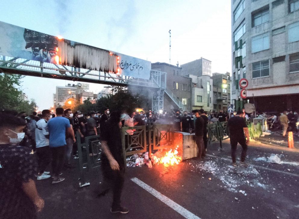 PHOTO: Iranian demonstrators burn a trash can in the capital Tehran during a protest in defense of Mahsa Amini days after she died in police custody, in a photo obtained September 21, 2022.