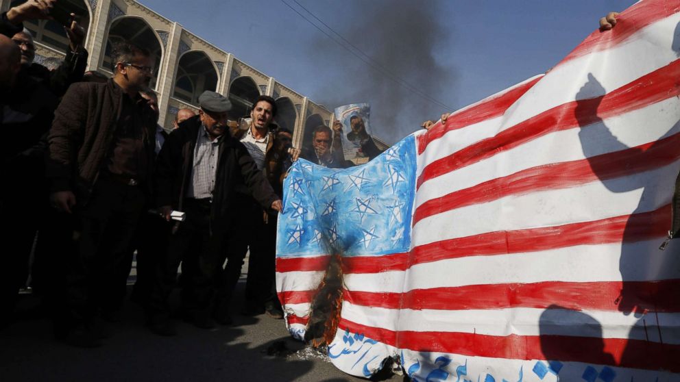 PHOTO: Iranian pro-government demonstrators set a makeshift US flag on fire during a march after the weekly Muslim Friday prayers in Tehran, Jan. 5, 2018.