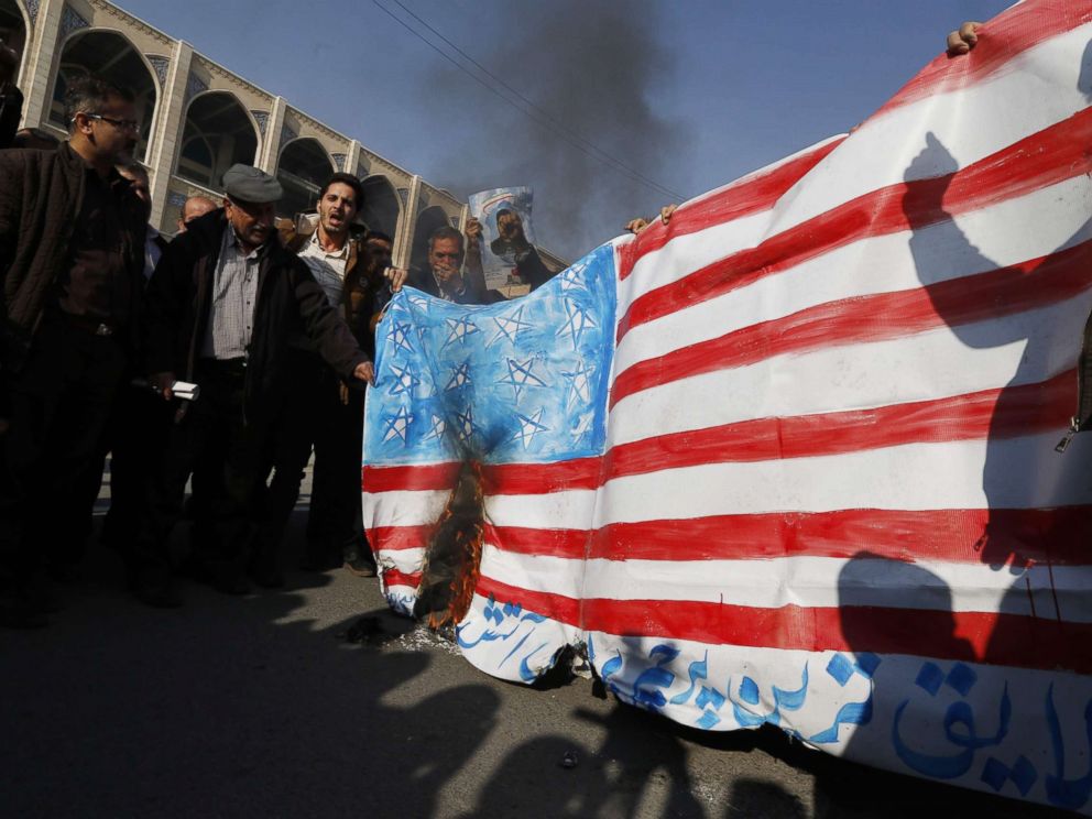 PHOTO: Iranian pro-government demonstrators set a makeshift US flag on fire during a march after the weekly Muslim Friday prayers in Tehran, Jan. 5, 2018.