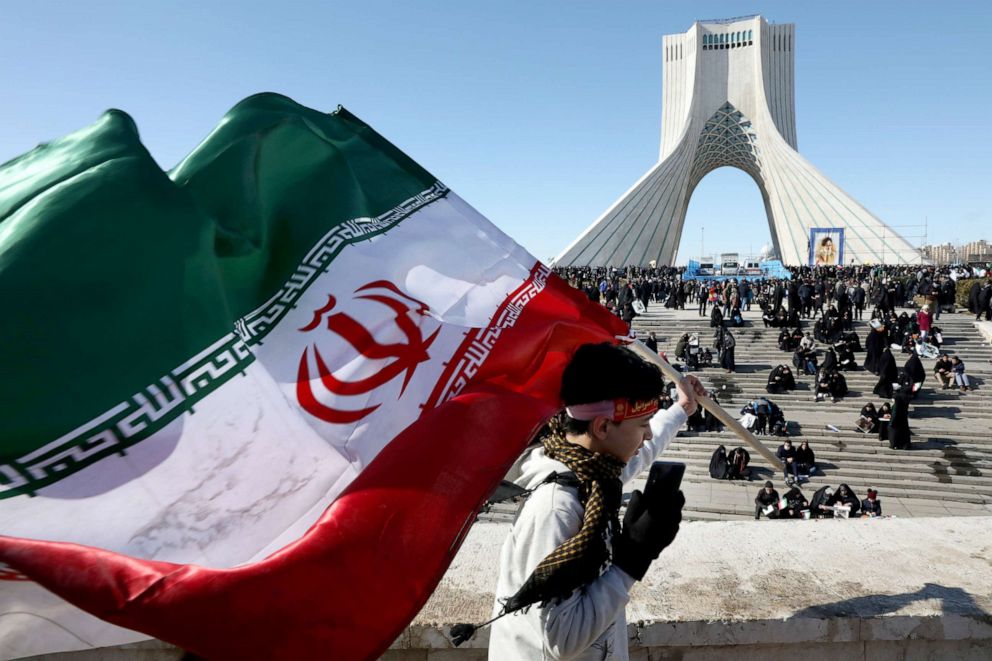 PHOTO: A boy carries an Iranian flag in front of Azadi (Freedom) monument tower in a rally celebrating the 41st anniversary of the Islamic Revolution, in Tehran, Iran, Feb. 11, 2020.