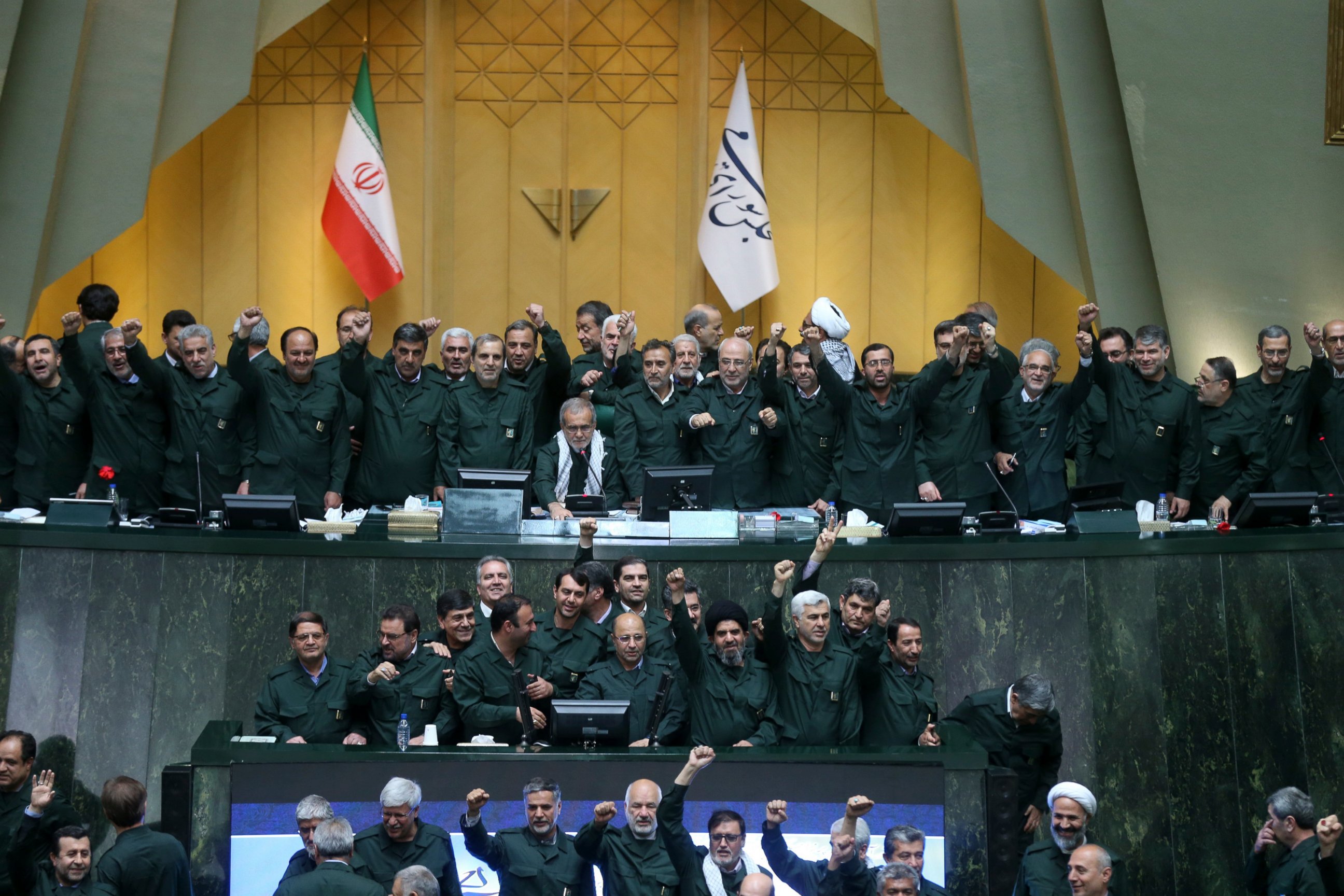 PHOTO: Wearing the uniform of the Iranian Revolutionary Guard, lawmakers chant slogans during an open session of parliament in Tehran, Iran, Tuesday, April 9, 2019.