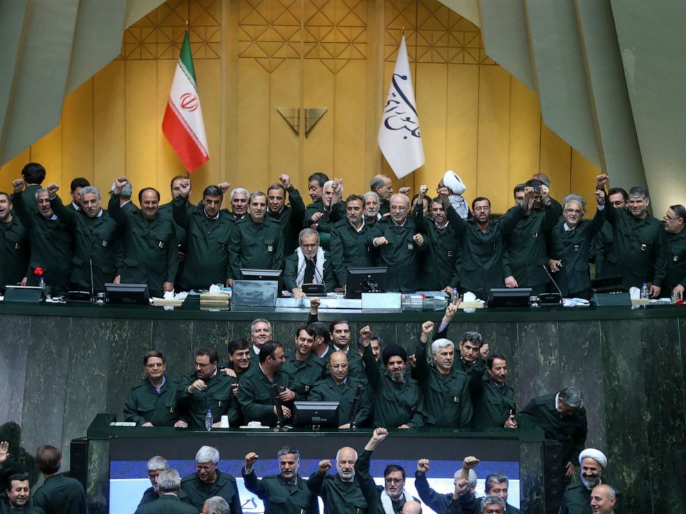 PHOTO: Wearing the uniform of the Iranian Revolutionary Guard, lawmakers chant slogans during an open session of parliament in Tehran, Iran, Tuesday, April 9, 2019.