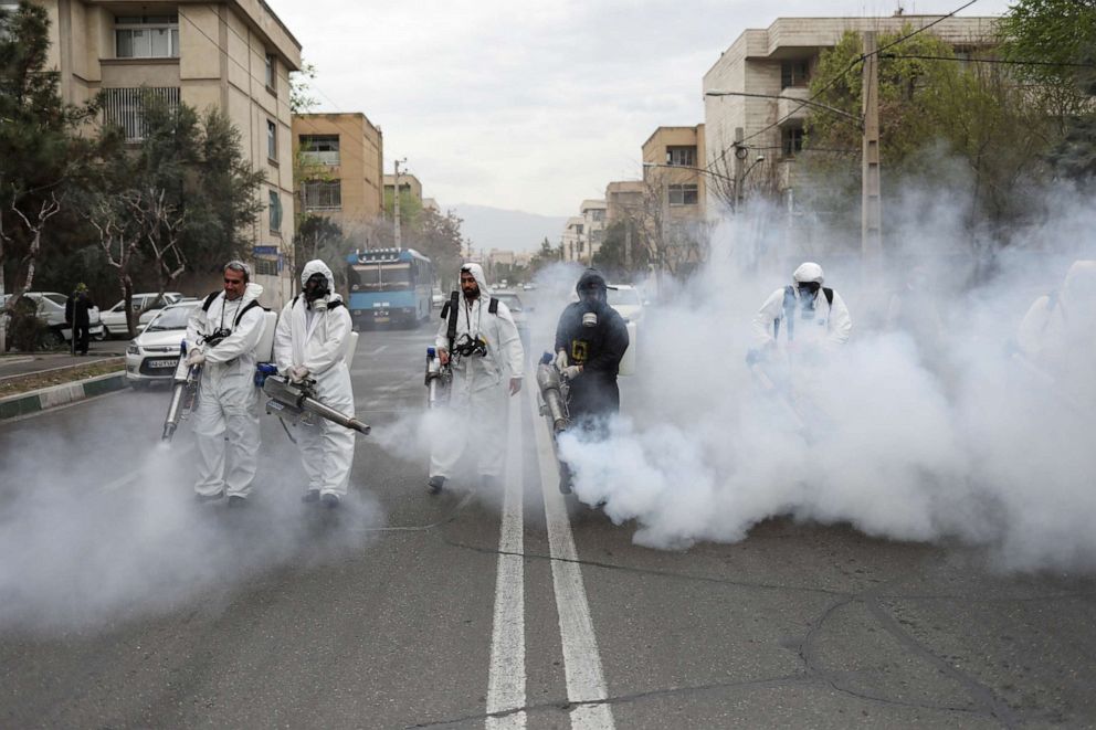 PHOTO: Members of firefighters wear protective face masks, amid fear of coronavirus disease, as they disinfect the streets, ahead of the Iranian New Year Nowruz, March 20, in Tehran, Iran March 18, 2020. 