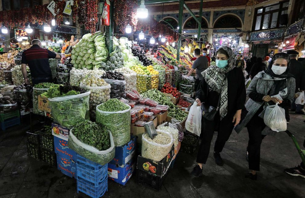 PHOTO: Mask-clad Iranians shop at the Tajrish Bazaar market in the capital Tehran, on November 1, 2020, amid the novel coronavirus pandemic crisis.