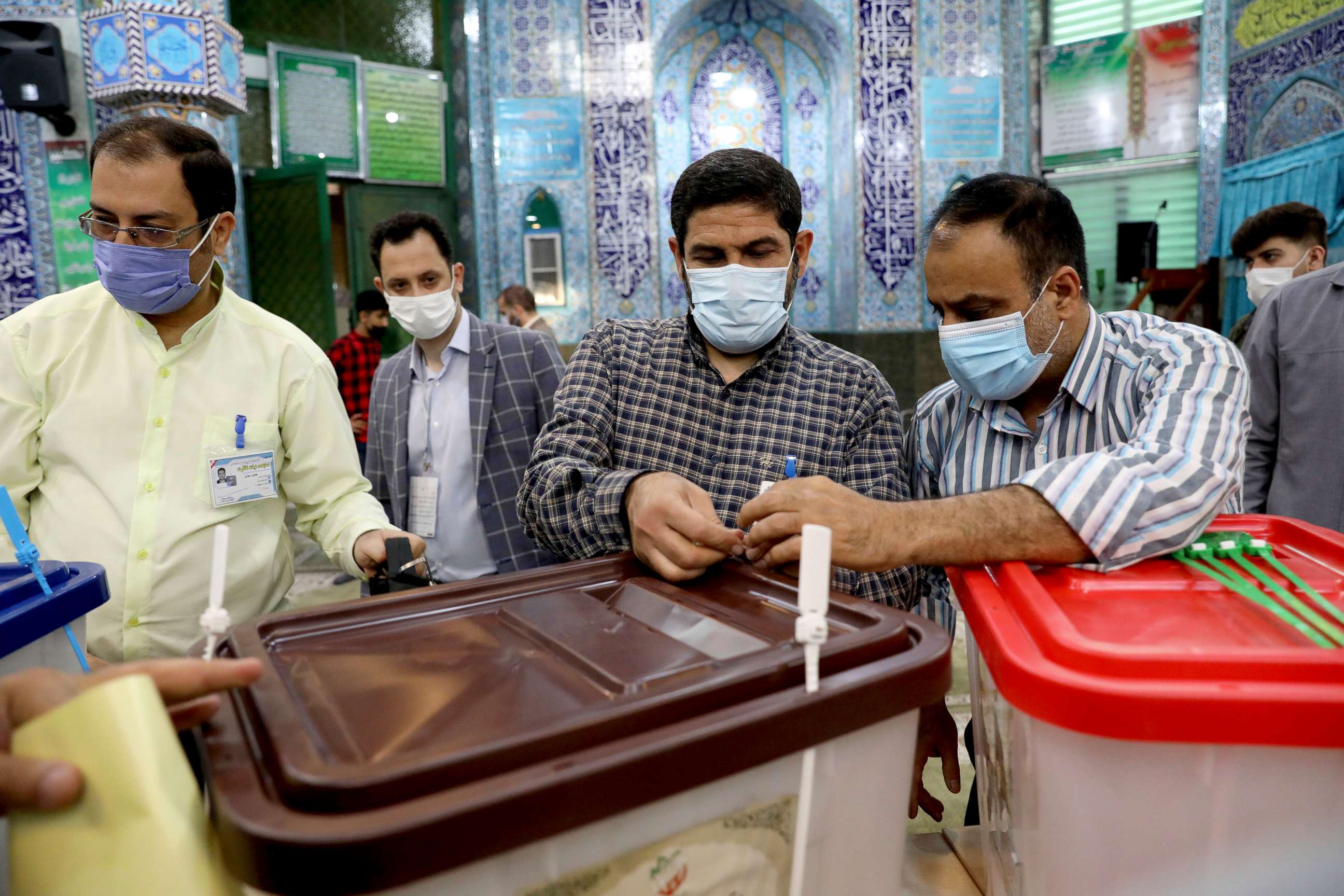 PHOTO: Iranian election officials prepare ballot boxes at a polling station in Tehran, Iran, Friday, June 18, 2021. Iran began voting Friday in a presidential election tipped in the favor of a hard-line protege of Supreme Leader Ayatollah Ali Khamenei. 
