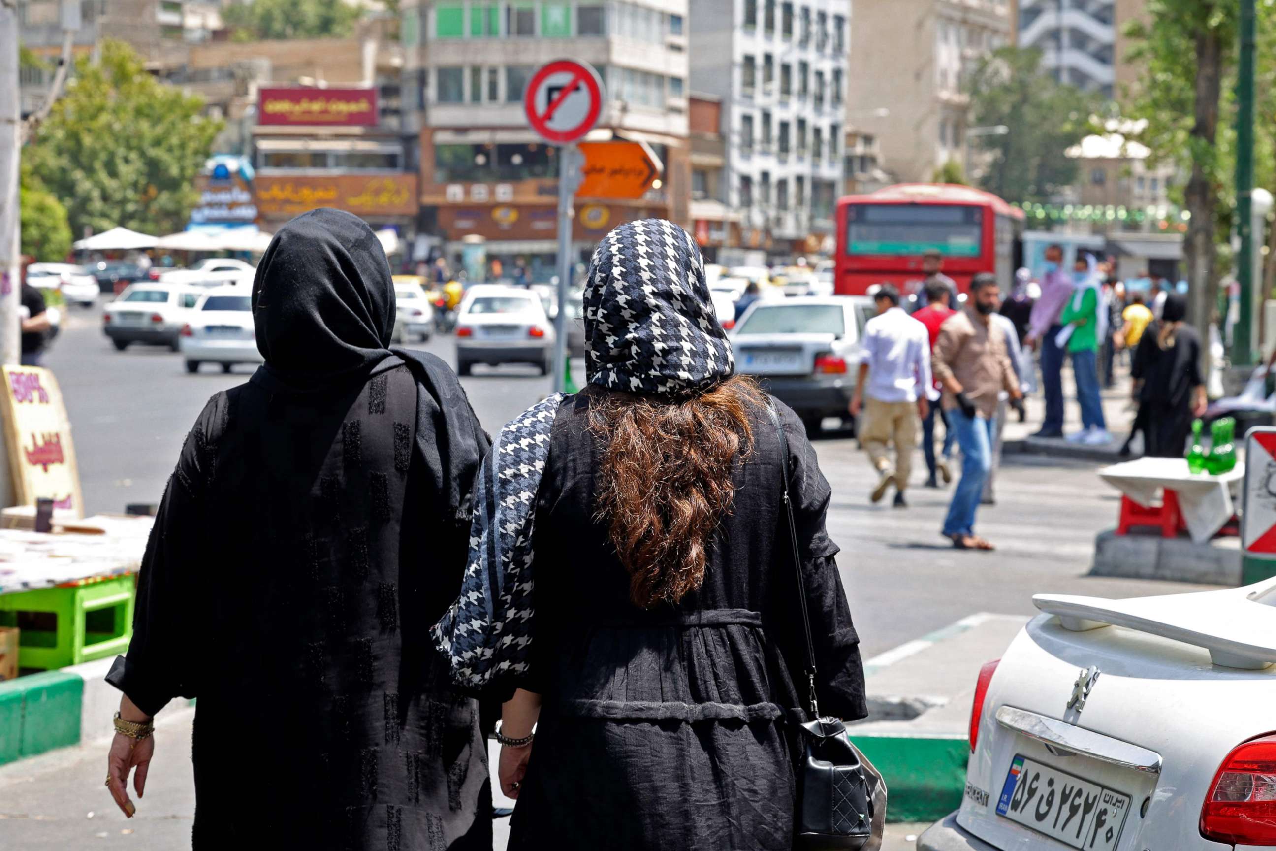 PHOTO: Women wearing headscarves walk in the streets of Tehran near, Tajrish Square, in Iran, on July 12, 2022.