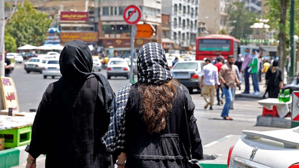 PHOTO: Women in headscarves walk through the streets of Tehran near Tajrish Square in Iran on July 12, 2022.