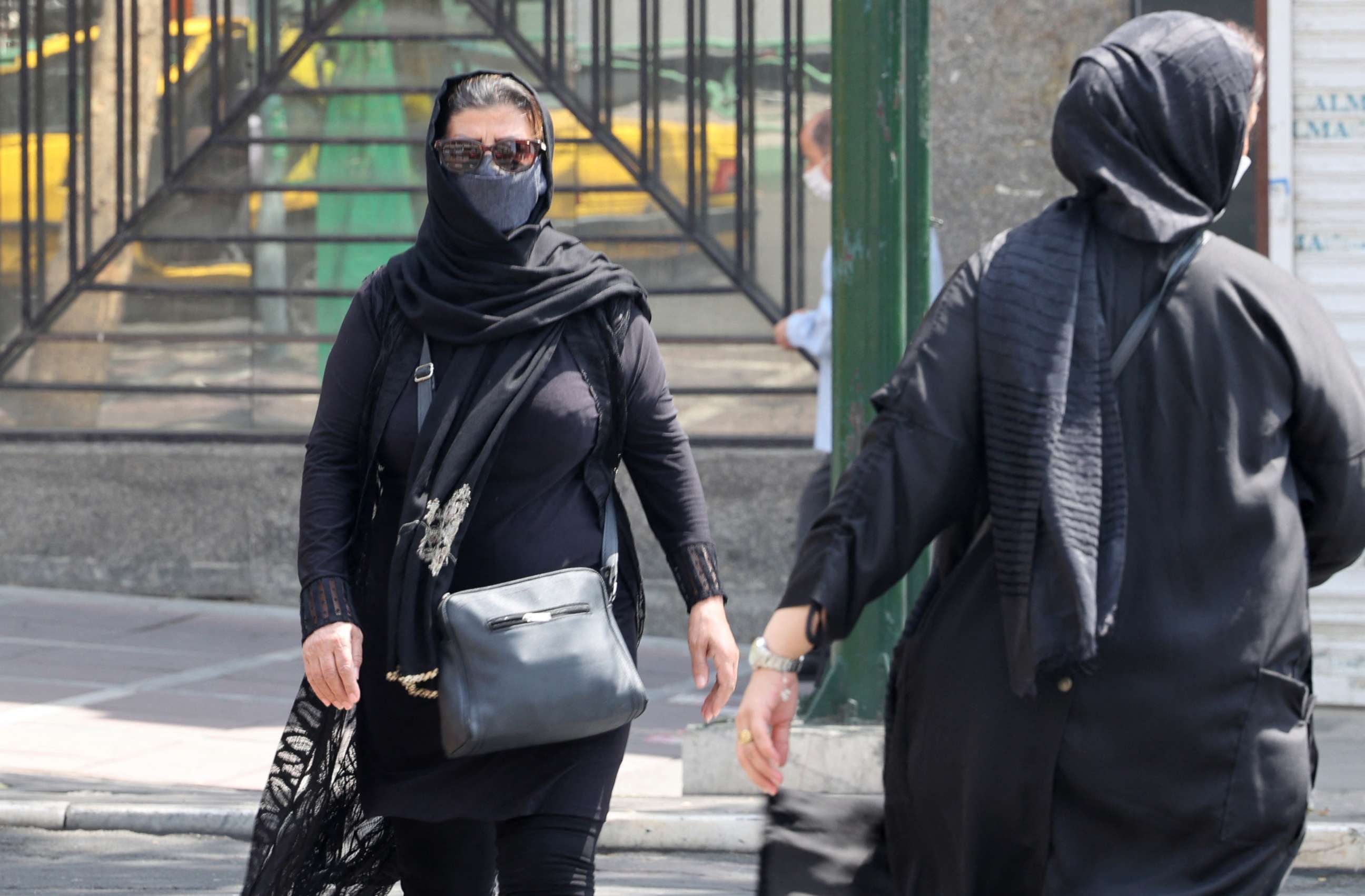 PHOTO: Women cross a street at Valiasr square in Tehran, Iran, on Aug. 16, 2021.