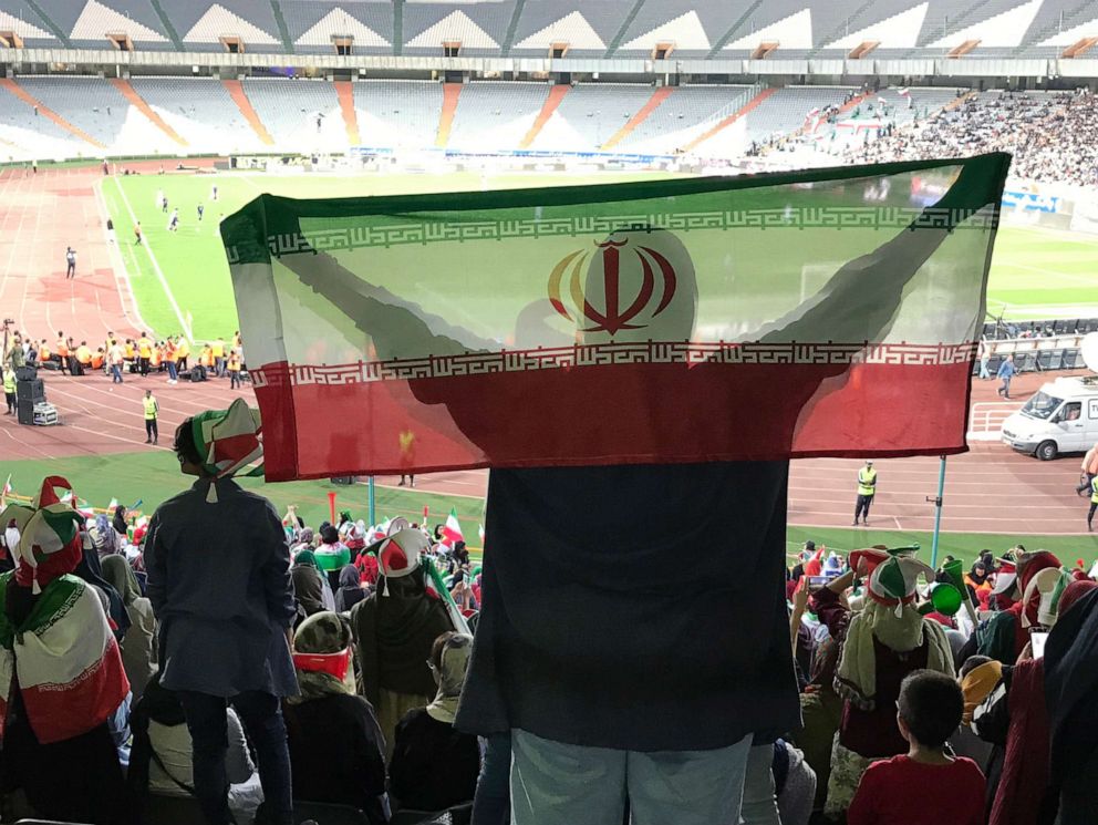 PHOTO: A woman holds the Iranian flag in the stands during the World Cup qualifying match between Iran and Cambodia at Azadi Stadium in Tehran, Iran, Oct. 10, 2019.