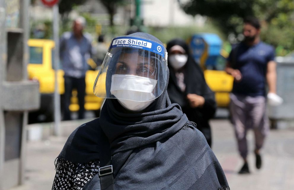 PHOTO: An Iranian woman wearing a face shield walks along a street in the capital of Tehran amid the coronavirus pandemic on Aug. 9, 2020.