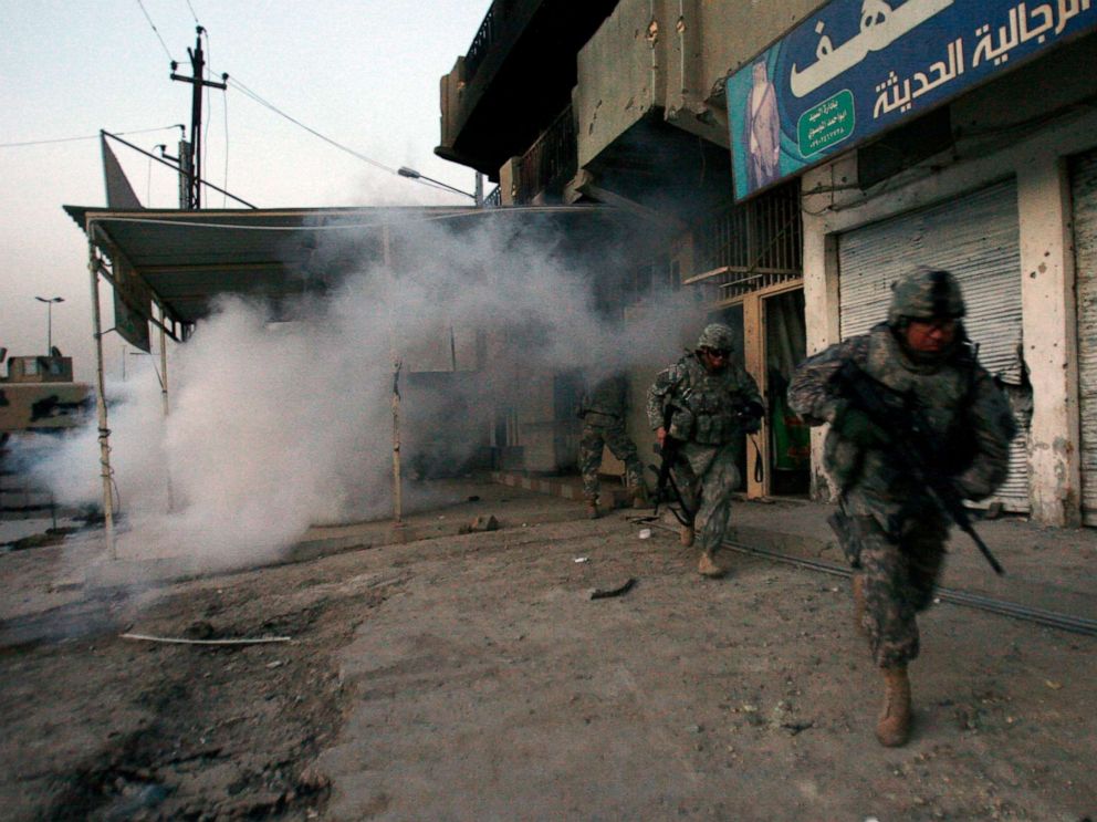 PHOTO: U.S. Army soldiers from the 3rd Special Troops Battalion use smoke to take cover from snipers as they make their way to their vehicles from a patrol base in the Shiite enclave of Sadr City in Baghdad, Iraq.