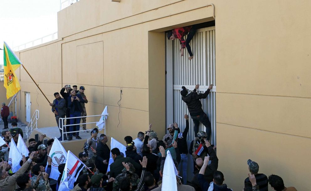 PHOTO: Hashd al-Shaabi (paramilitary forces) fighters try to enter the U.S. Embassy during a protest to condemn air strikes on their bases, in Baghdad, Dec. 31, 2019.