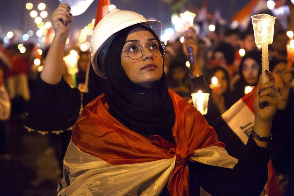 PHOTO: Iraqi architects wear white helmets as they hold a candlelight vigil for victims killed during anti-government protests in the southern city of Basra on Nov. 1, 2019.