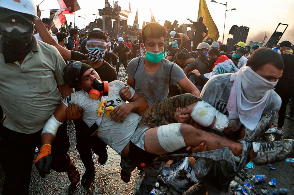 PHOTO: An injured protester is rushed away from the scene during an anti-government protest in Baghdad, Iraq, Oct. 29, 2019.