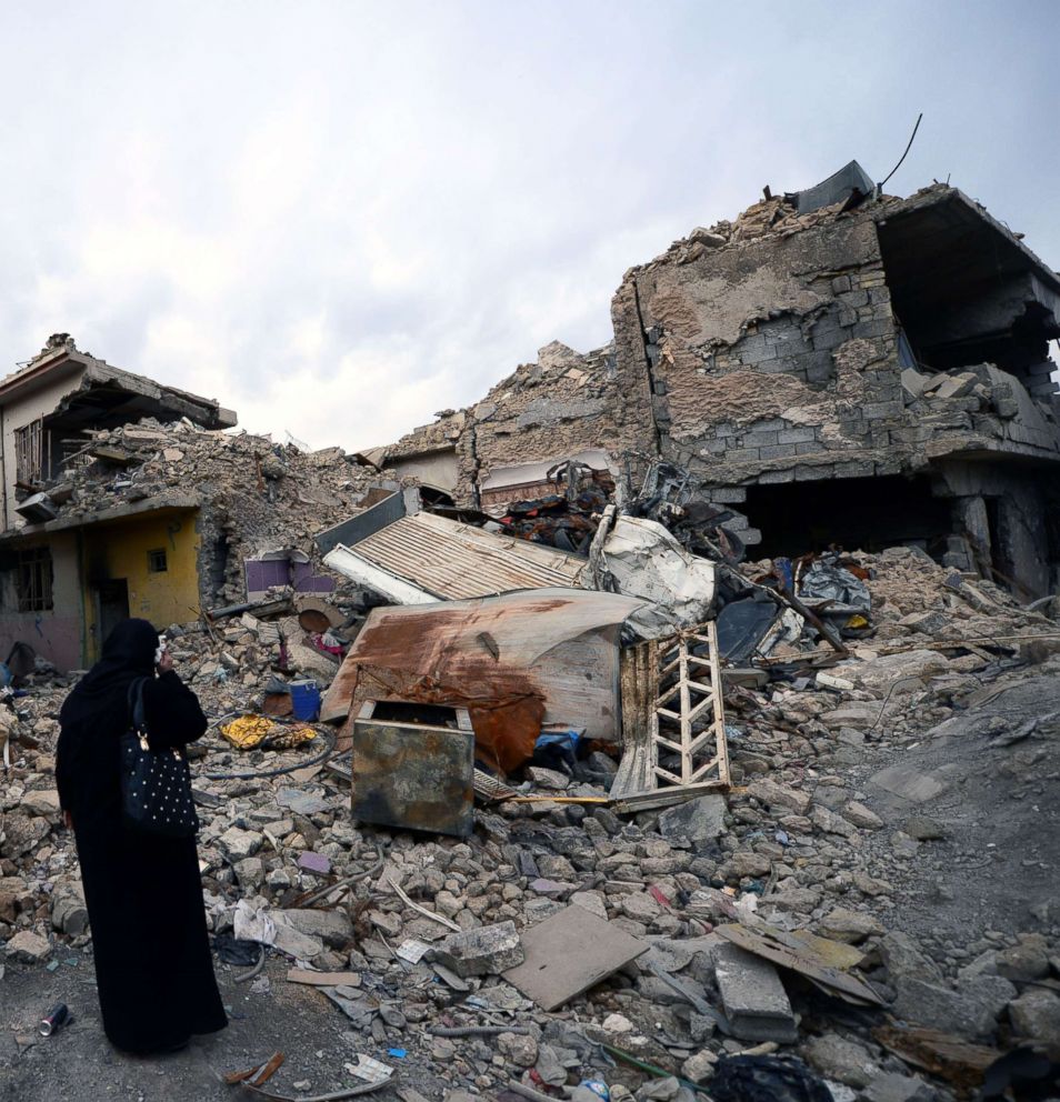 PHOTO: An Iraqi woman inspects the destruction in the old city district in the western part of Mosul city, Iraq, Feb. 3, 2018.