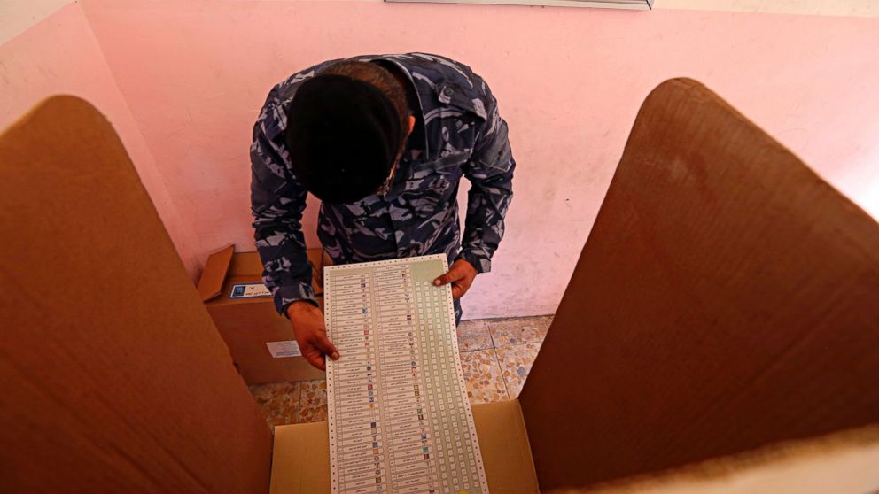 In this Thursday, May 10, 2018 file photo, an Iraqi Federal policeman prepares to cast his vote at a polling center in Baghdad, Iraq. Voters will cast their ballots Saturday, May 12, in the first parliamentary election since the country declared victory over the Islamic State extremist group.