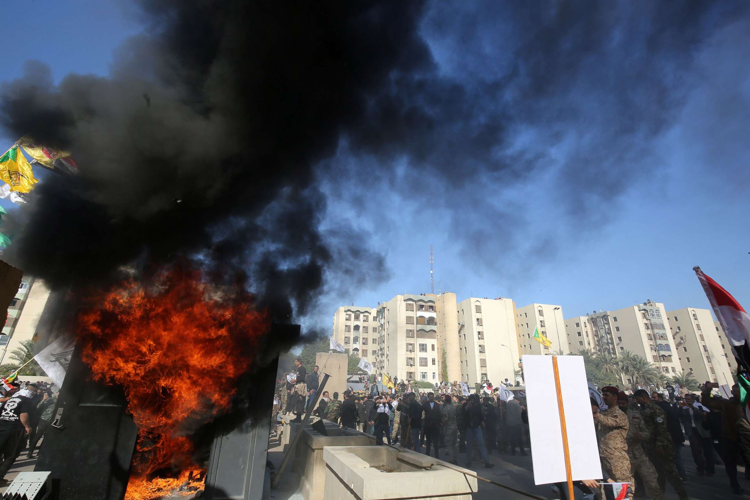 PHOTO: Iraqi protesters set ablaze a sentry box in front of the US embassy building in the capital Baghdad to protest against the weekend's air strikes by US planes on several bases, on December 31, 2019.