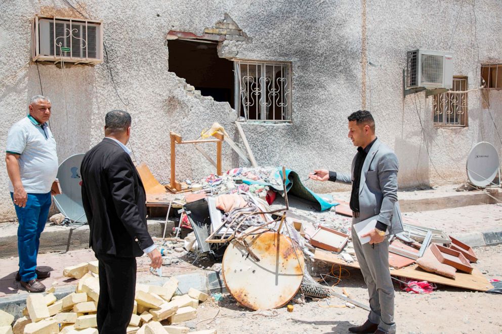 PHOTO:Iraqis inspect the damage at a drilling fascility that was hit by a Katyusha rocket in the Burjesiya area, a key oil-producing region hosting various Iraqi and foreign companies north of the Iraqi city of Basra on June 19, 2019.